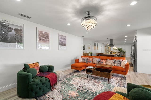 living room featuring light hardwood / wood-style flooring and a chandelier