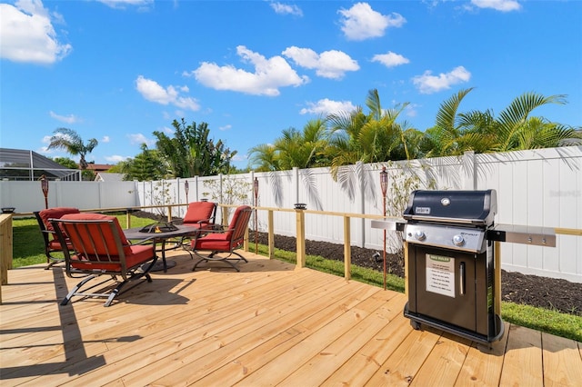 deck with a grill and a fire pit