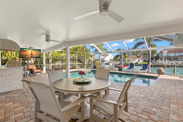 sunroom / solarium featuring a swimming pool, ceiling fan, and a water view