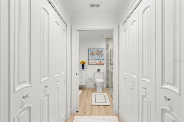 bathroom with wood-type flooring, toilet, a shower with shower door, and vanity