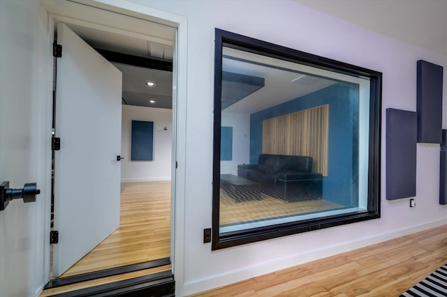 interior space featuring baseboards and wood finished floors