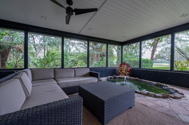 sunroom / solarium featuring ceiling fan