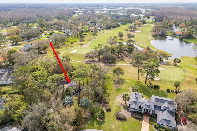 birds eye view of property with a water view and golf course view