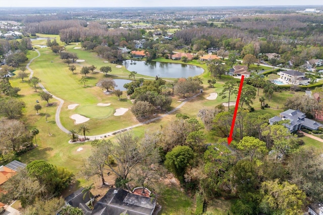 drone / aerial view with a water view and golf course view