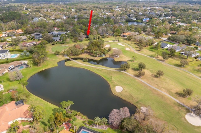 drone / aerial view featuring view of golf course and a water view