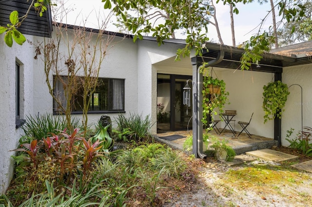 rear view of house with stucco siding