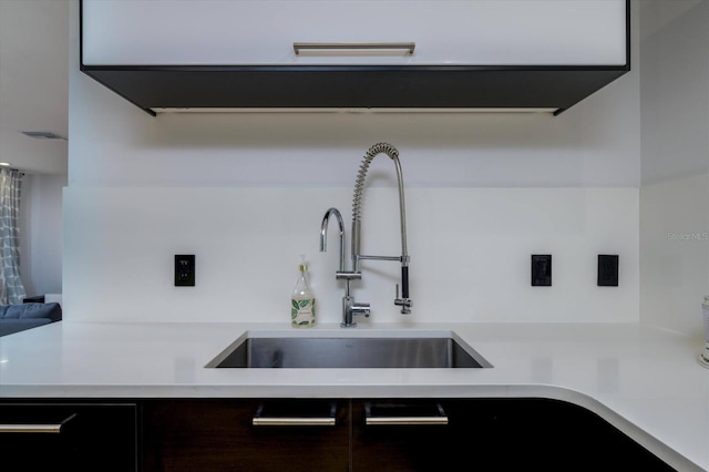 kitchen with light countertops and a sink