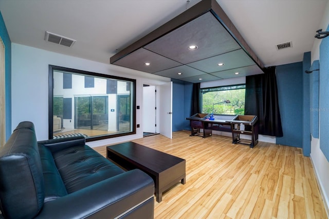 home theater with light wood-style flooring, visible vents, and recessed lighting