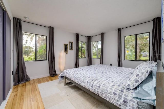 bedroom with baseboards and wood finished floors