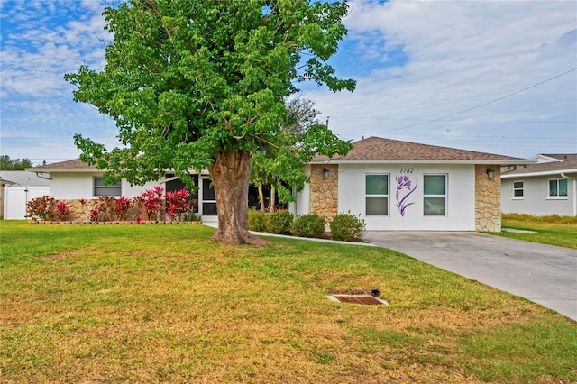 view of front of home featuring stone siding, a front lawn, and stucco siding