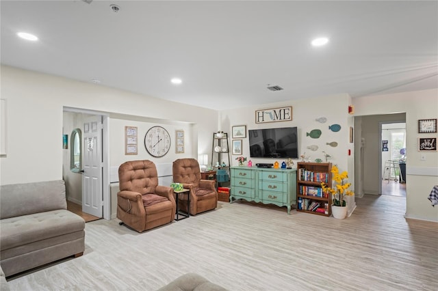 living room featuring recessed lighting, visible vents, and light wood-style floors