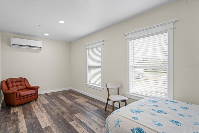 bedroom featuring dark wood-type flooring, a wall unit AC, recessed lighting, and baseboards