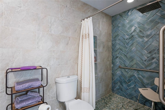 full bathroom with a shower stall, toilet, and tile walls