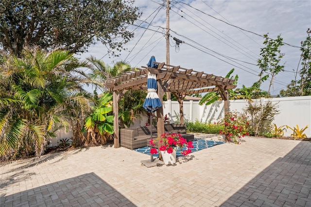 view of patio / terrace with a fenced backyard, an outdoor living space, and a pergola