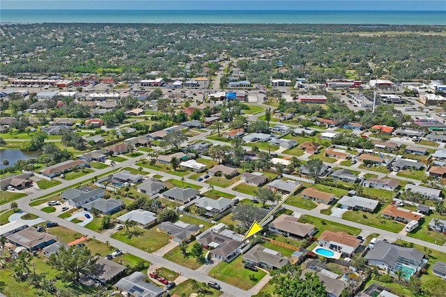 birds eye view of property with a water view and a residential view