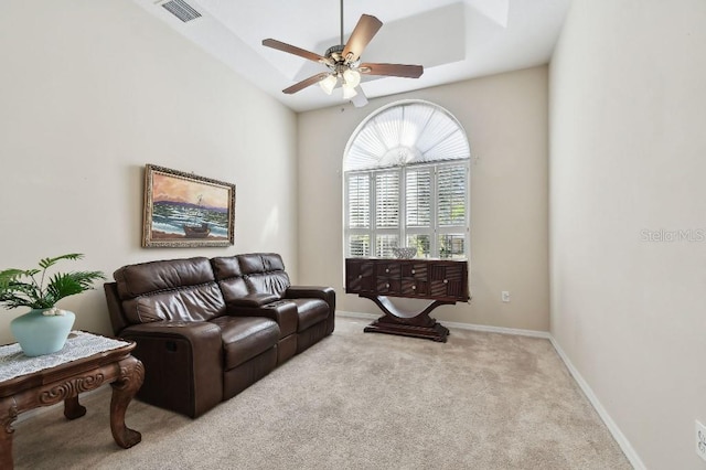 carpeted living room with ceiling fan