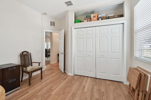 sitting room featuring radiator and light hardwood / wood-style floors