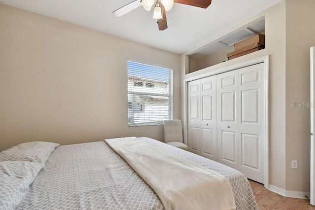 bedroom featuring ceiling fan, a closet, and light wood-type flooring