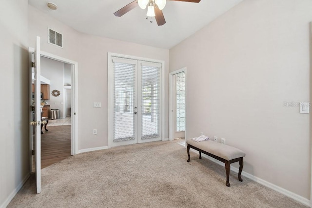 interior space featuring light carpet, ceiling fan, and french doors