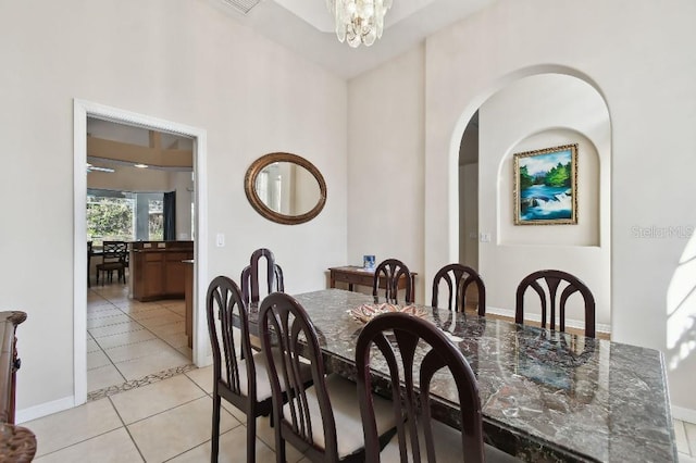 tiled dining area with a notable chandelier