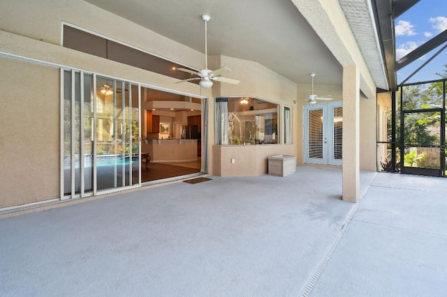 view of patio / terrace with french doors, ceiling fan, and glass enclosure