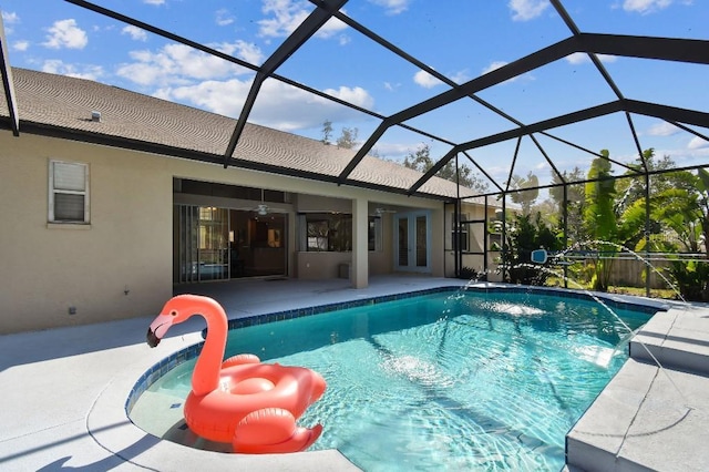 view of swimming pool featuring a patio and glass enclosure