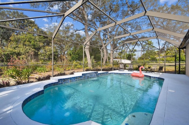 view of swimming pool with a lanai and a patio area