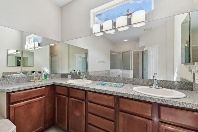 bathroom featuring vanity and an enclosed shower