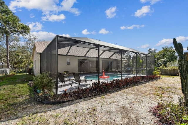 view of swimming pool featuring a patio area and glass enclosure