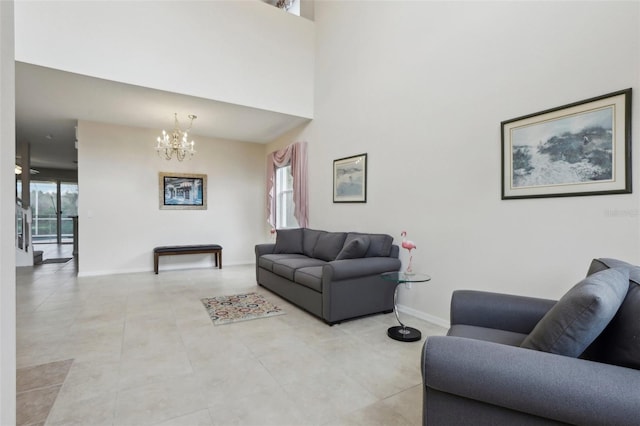 living room with a towering ceiling, a chandelier, plenty of natural light, and light tile patterned floors