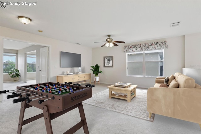 recreation room featuring ceiling fan and light carpet