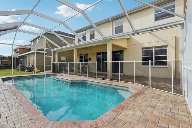 view of pool with a patio, ceiling fan, and a lanai