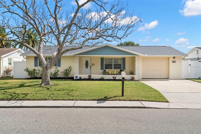 ranch-style home with a garage, covered porch, and a front lawn