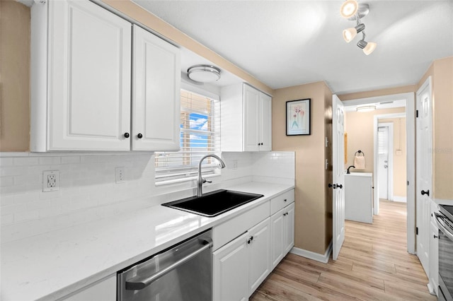 kitchen featuring stainless steel appliances, white cabinetry, and sink