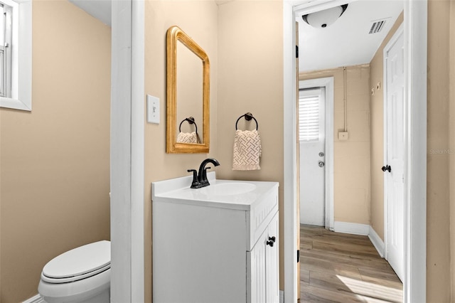 bathroom with vanity, hardwood / wood-style floors, and toilet