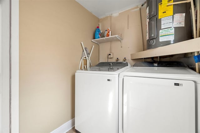 clothes washing area with washing machine and dryer and electric water heater