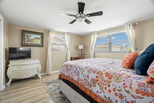 bedroom with ceiling fan and light wood-type flooring