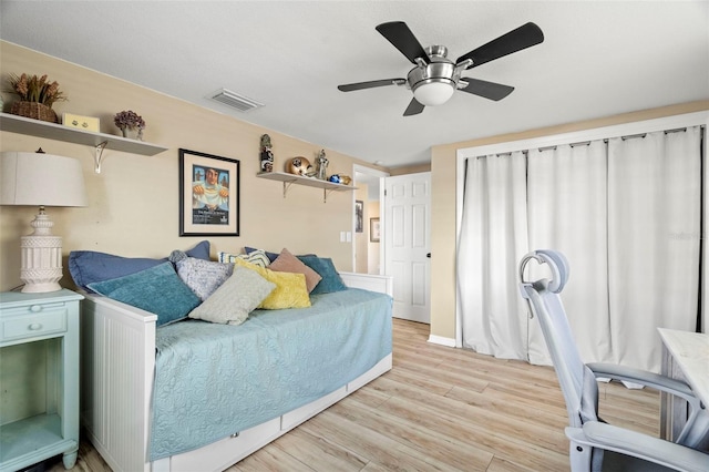 bedroom with light hardwood / wood-style flooring and ceiling fan