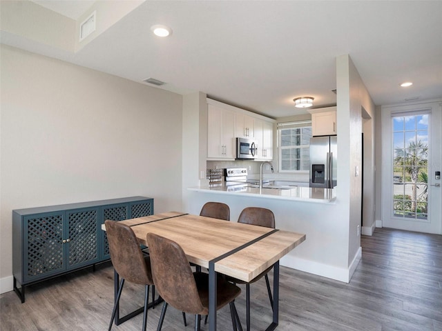 dining room with wood-type flooring