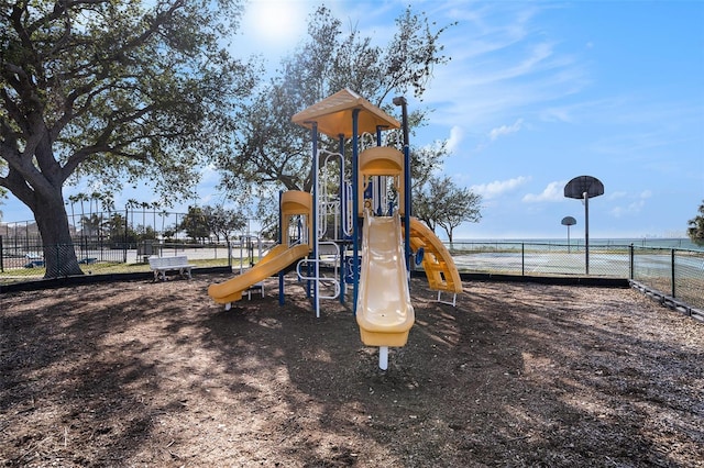 view of jungle gym with a water view