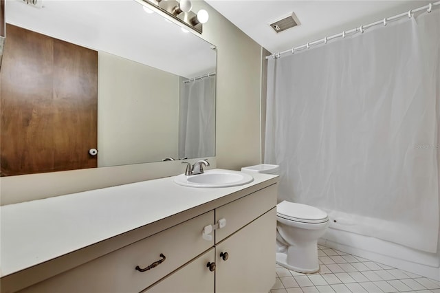 bathroom with toilet, vanity, tile patterned flooring, and walk in shower