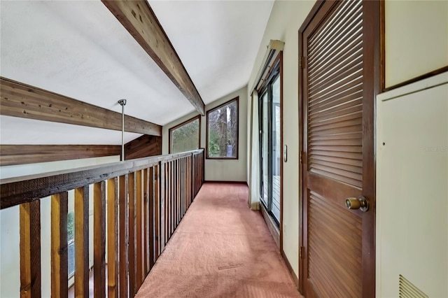 hallway featuring beamed ceiling and carpet flooring