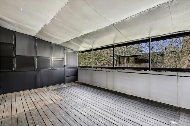 unfurnished sunroom featuring lofted ceiling