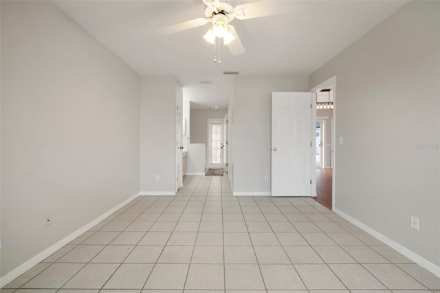 empty room featuring light tile patterned floors and ceiling fan