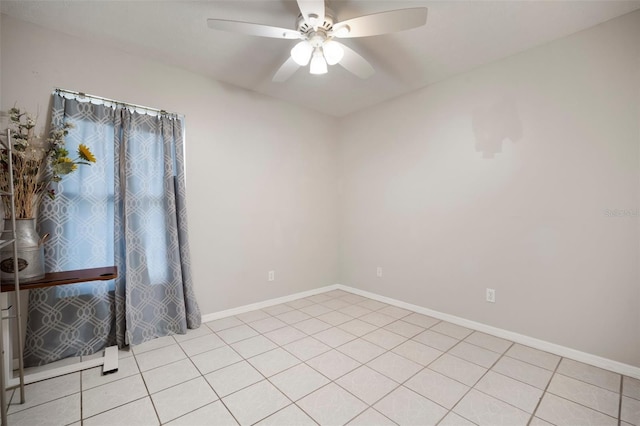 tiled spare room featuring ceiling fan