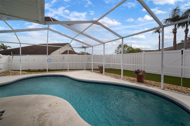 view of swimming pool with a patio and glass enclosure