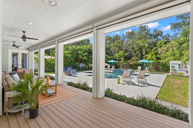 unfurnished sunroom featuring ceiling fan