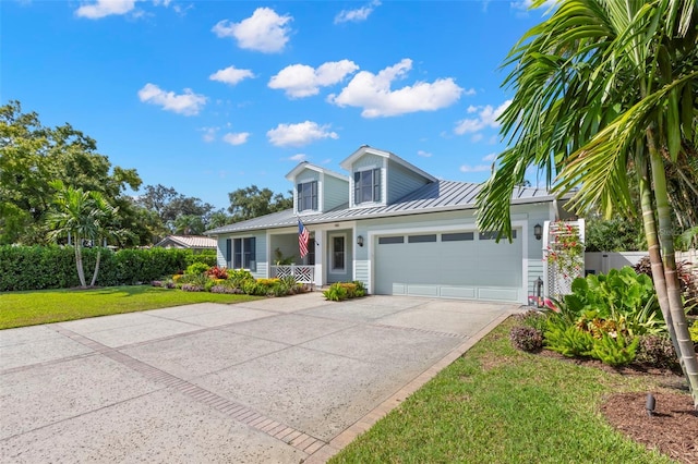 view of front of property with a garage and a front lawn