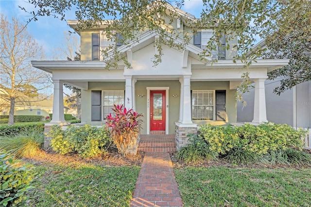 view of front of house featuring a porch and stucco siding