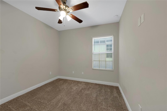 empty room featuring ceiling fan, carpet floors, and baseboards